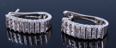 Lot 2587 - A pair of white metal diamond set hinged hoop...