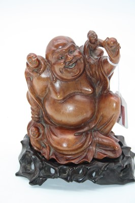 Lot 234 - A softwood figure carved as Budai, in seated...