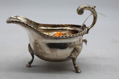 Lot 301 - A George V silver sauceboat, having gadrooned...