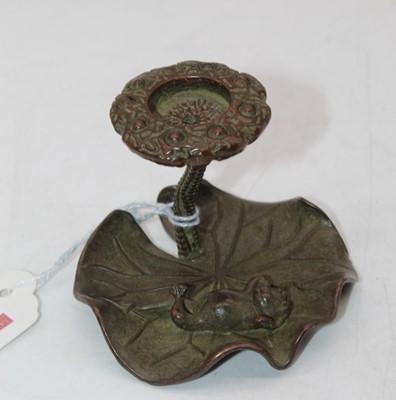 Lot 549 - A Japanese style bronze lily-pad candle holder,...