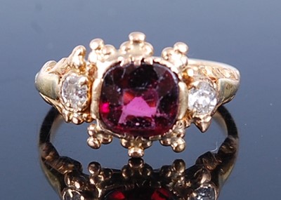 Lot 2604 - A yellow metal, garnet and diamond dress ring,...