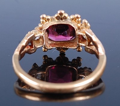 Lot 2604 - A yellow metal, garnet and diamond dress ring,...