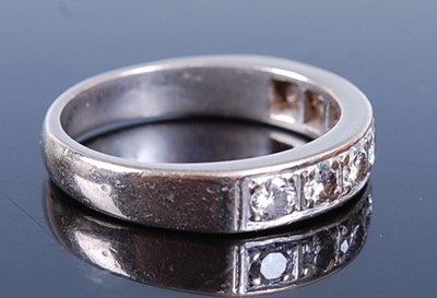 Lot 2627 - A white metal diamond half hoop eternity ring,...