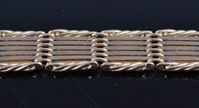 Lot 2617 - A 15ct gold gatelink bracelet, with ropetwist...