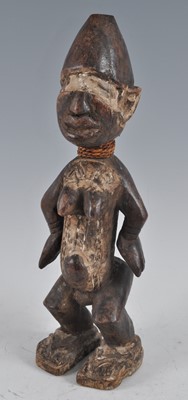 Lot 2396 - A wooden fetish figure, carved as a female in...