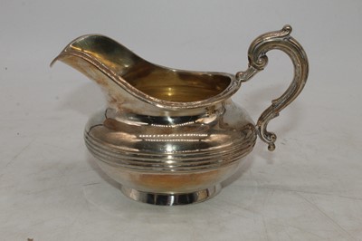 Lot 251 - A Victorian silver teapot and cream jug, each...