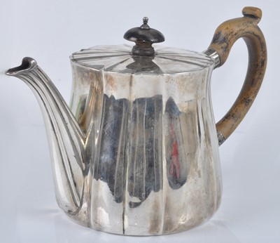Lot 1108 - A George V silver teapot, of fluted lightly...