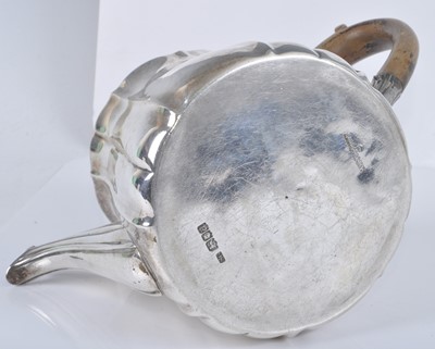 Lot 1108 - A George V silver teapot, of fluted lightly...
