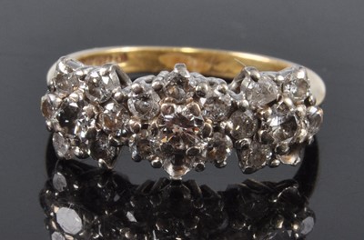 Lot 2647 - An 18ct yellow and white gold diamond triple...