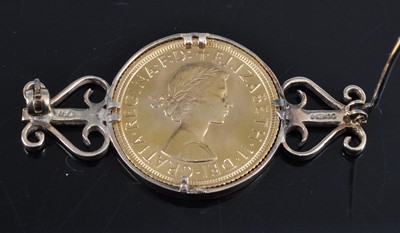 Lot 2680 - A 9ct gold sovereign brooch, set with a single...