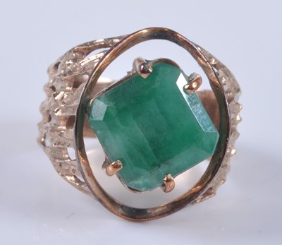 Lot 2667 - A yellow metal emerald set dress ring, the...