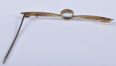 Lot 2672 - A yellow metal aquamarine bar brooch, the oval...