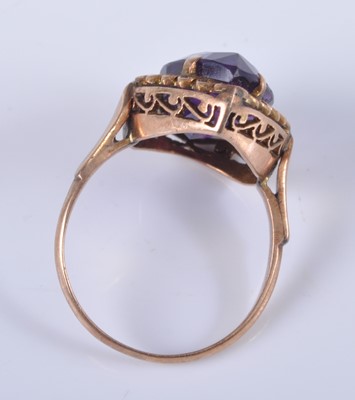 Lot 2678 - A yellow metal and amethyst set dress ring,...