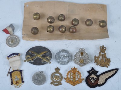 Lot 14 - A collection of cap badges, buttons and...