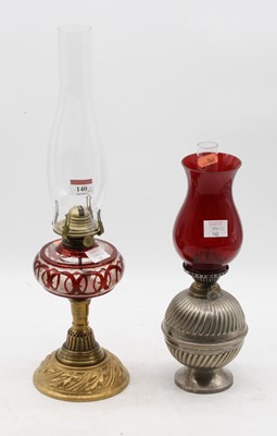 Lot 140 - A late Victorian oil lamp, having a ruby...