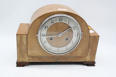 Lot 150 - A 1950s oak cased mantel clock, having a...
