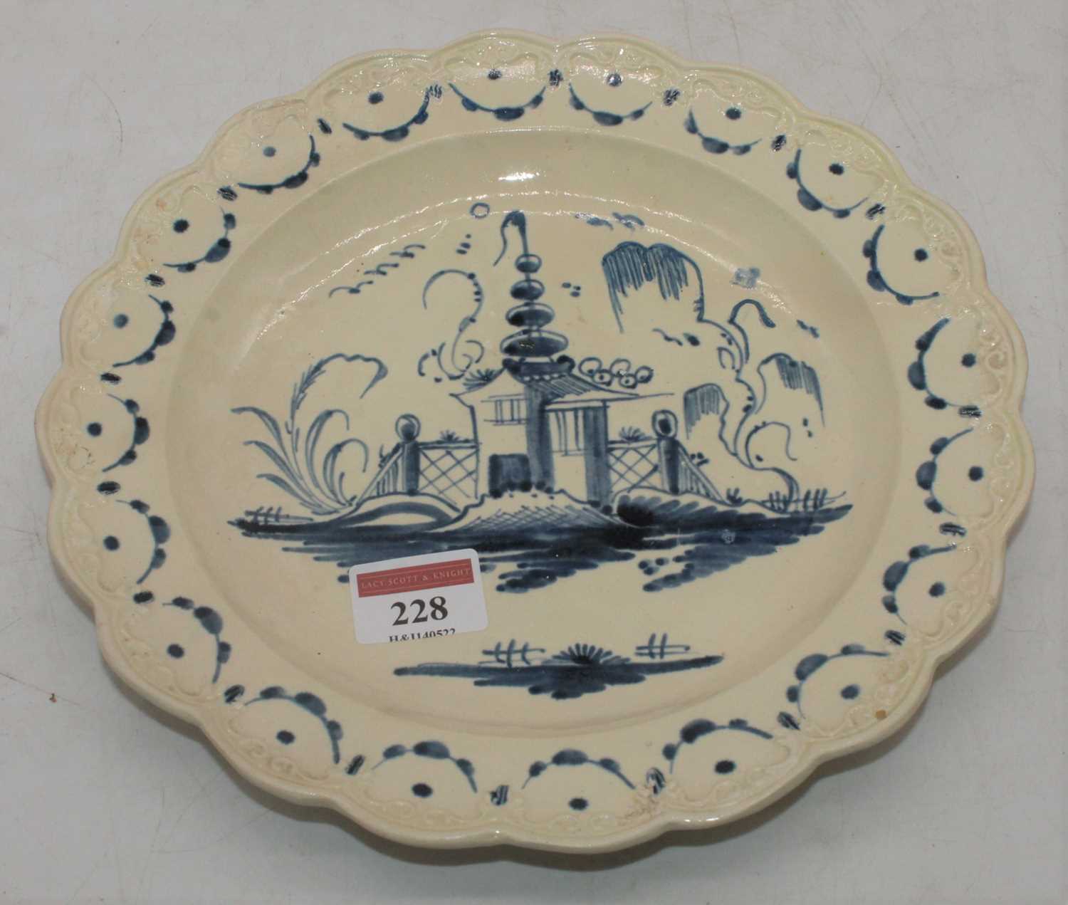 Lot 228 - An 18th century creamware plate decoration...