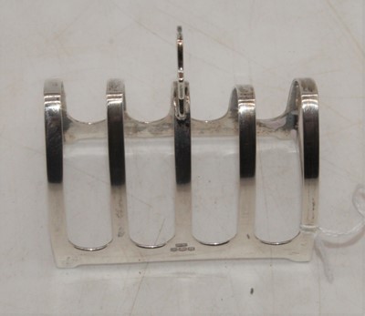 Lot 248 - A George VI silver four division toast rack,...