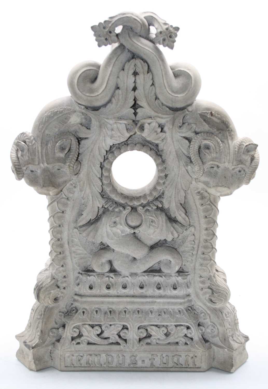 Lot 114 - A large ornately carved stone clock case, the...