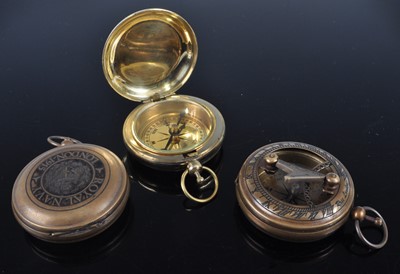 Lot 309 - A reproduction brass pocket compass; together...