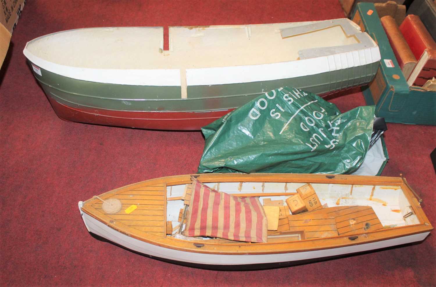 Lot 549 - A fibreglass model ships hull, together with...