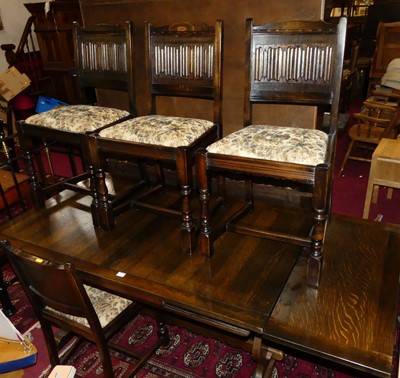 Lot 1325 - An Old Charm moulded oak dining suite,...