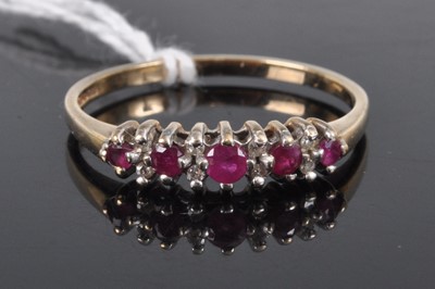 Lot 326 - A 9ct gold, ruby and diamond point set half...