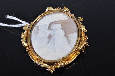 Lot 330 - A carved shell cameo brooch in pinchbeck mount,...