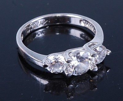 Lot 338 - A white metal and cz set three-stone ring,...