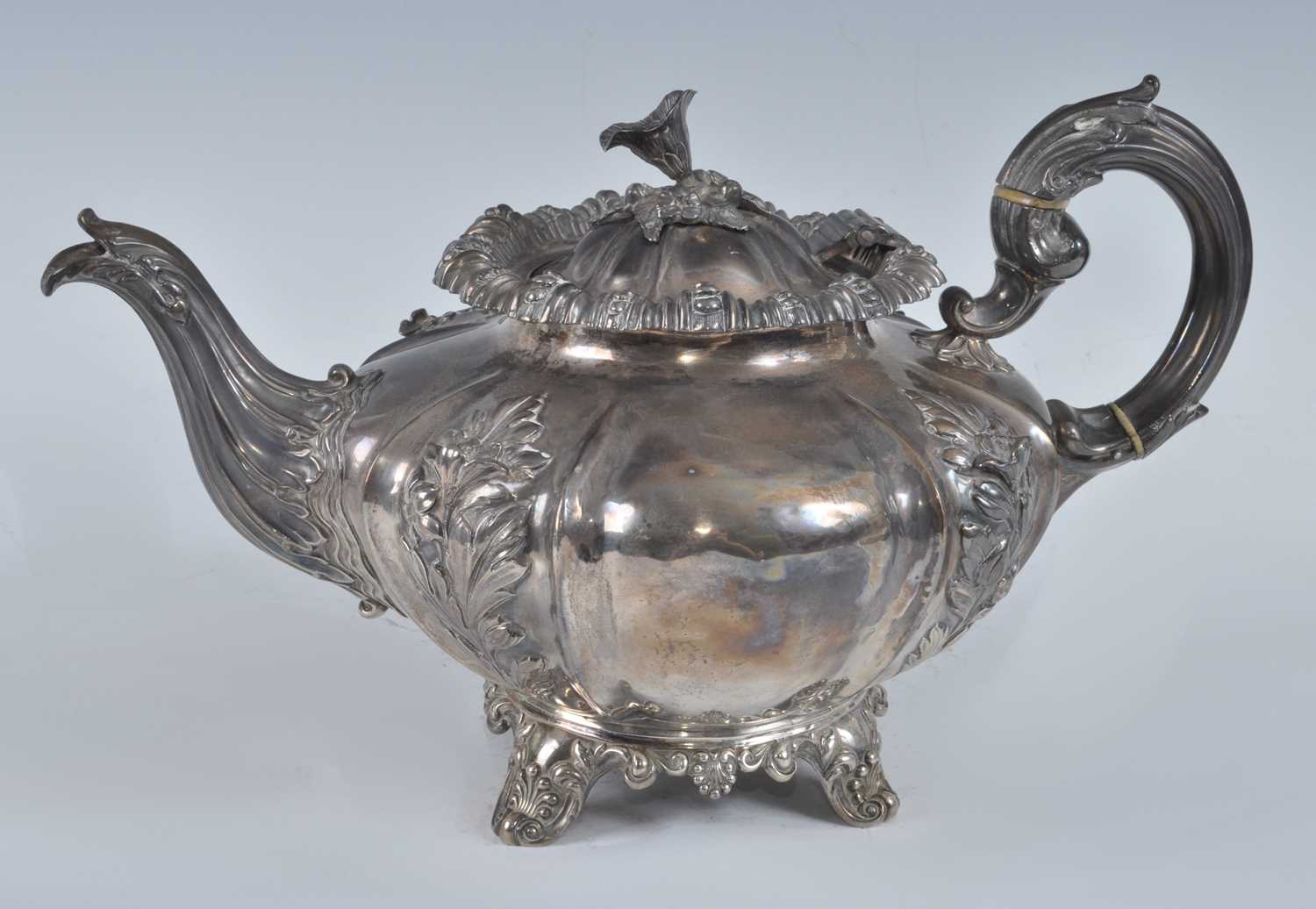 Lot 1078 - A William IV silver teapot, of fluted melon...