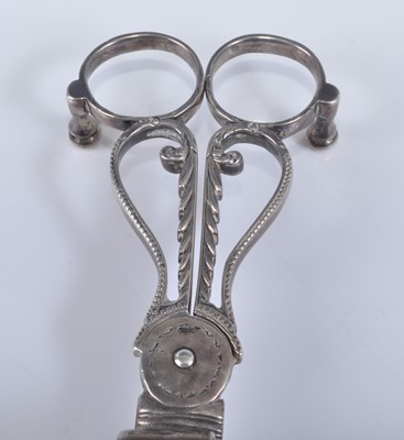 Lot 1064 - A pair of George III silver wick scissors,...