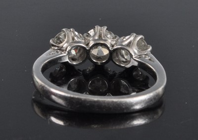 Lot 1131 - A white metal diamond three stone ring,...