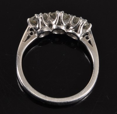 Lot 1131 - A white metal diamond three stone ring,...