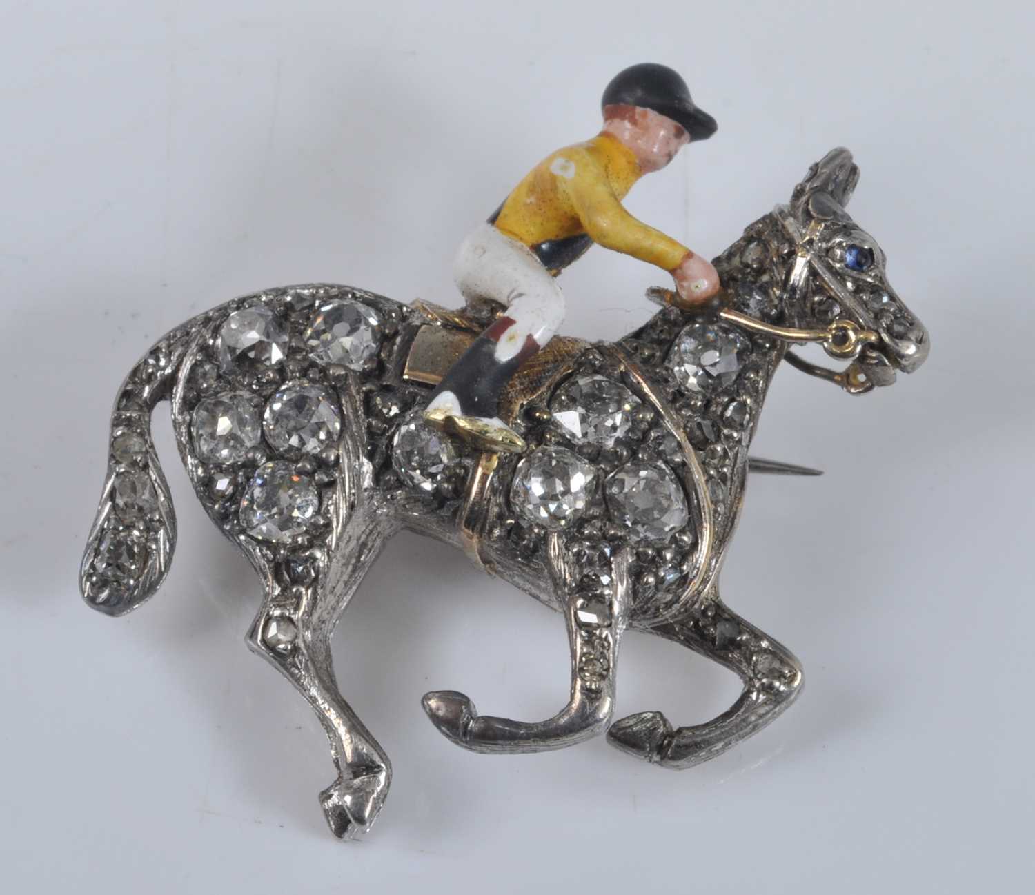 Lot 1133 - A yellow and white metal horse and jockey...