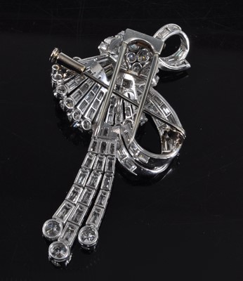 Lot 1142 - An Art Deco white metal diamond swag and bow...