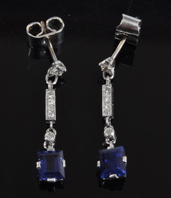 Lot 1145 - A pair of white metal Art Deco style sapphire...