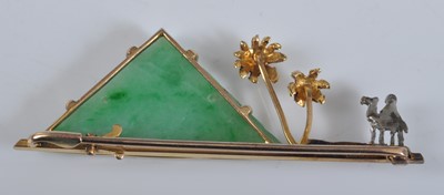 Lot 1134 - A yellow metal bar brooch, featuring a carved...