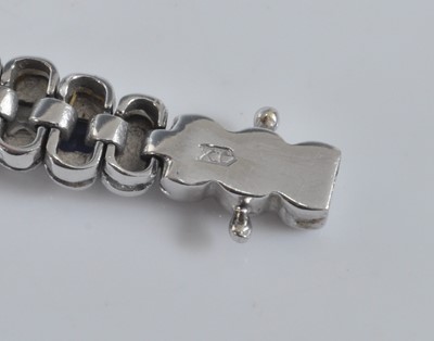 Lot 1160 - A white metal sapphire line bracelet,...