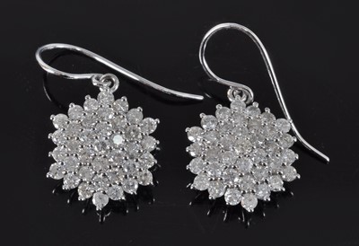 Lot 1167 - A pair of white metal diamond circular cluster...