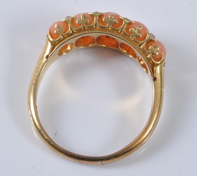 Lot 1173 - A yellow metal coral half hoop eternity ring,...