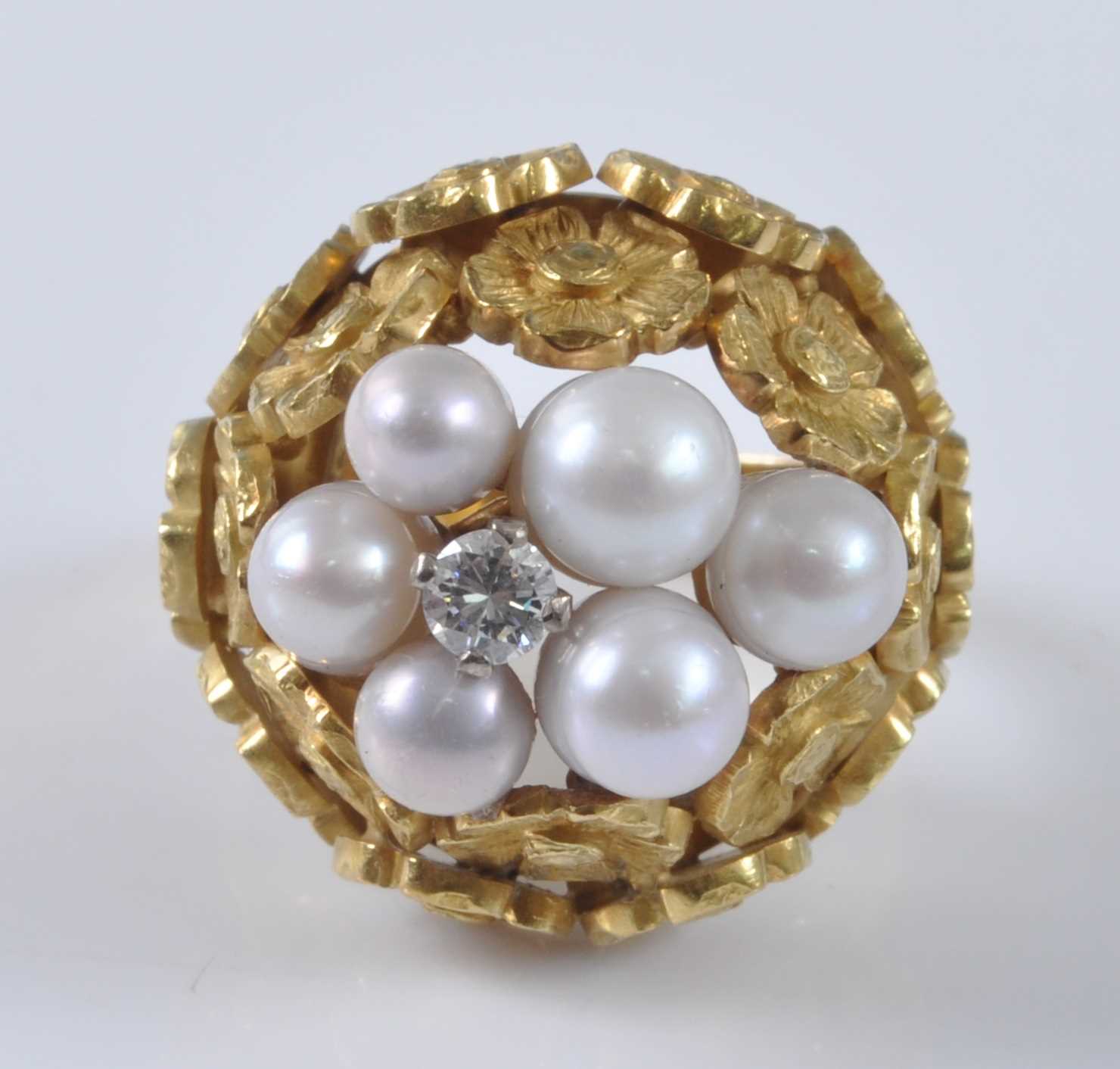 Lot 1175 - A yellow metal, pearl and diamond bombe ring,...