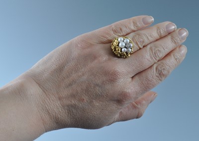 Lot 1175 - A yellow metal, pearl and diamond bombe ring,...