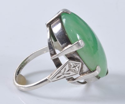 Lot 1177 - A white metal jadeite dress ring, featuring an...