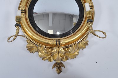 Lot 1430 - A late Regency giltwood and gesso convex wall...