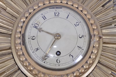 Lot An Art Deco gilt decorated sunburst wall clock,...