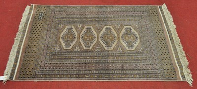 Lot 1383 - A Persian woollen Bokhara rug, the faded mauve...