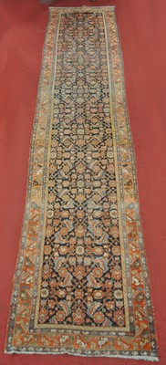 Lot 1384 - A Persian woollen hall runner, the blue ground...
