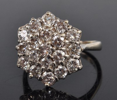 Lot 1185 - An 18ct white gold diamond circular cluster...