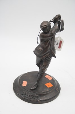 Lot 48 - A reproduction bronzed figure of a golfer in...