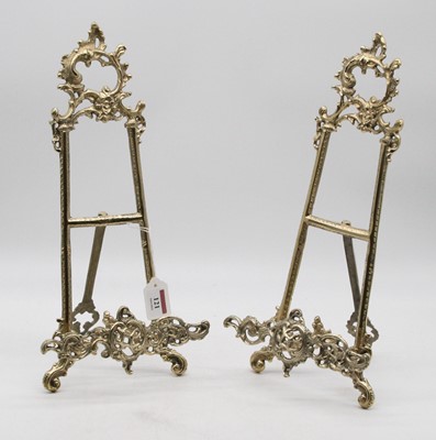 Lot 121 - A pair of reproduction brass easel stands in...